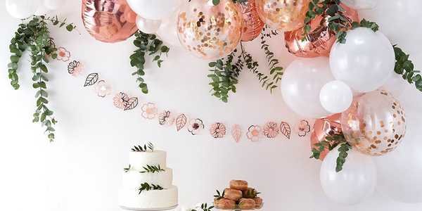 White, pink and metallic balloons used to decorate a wedding venue.